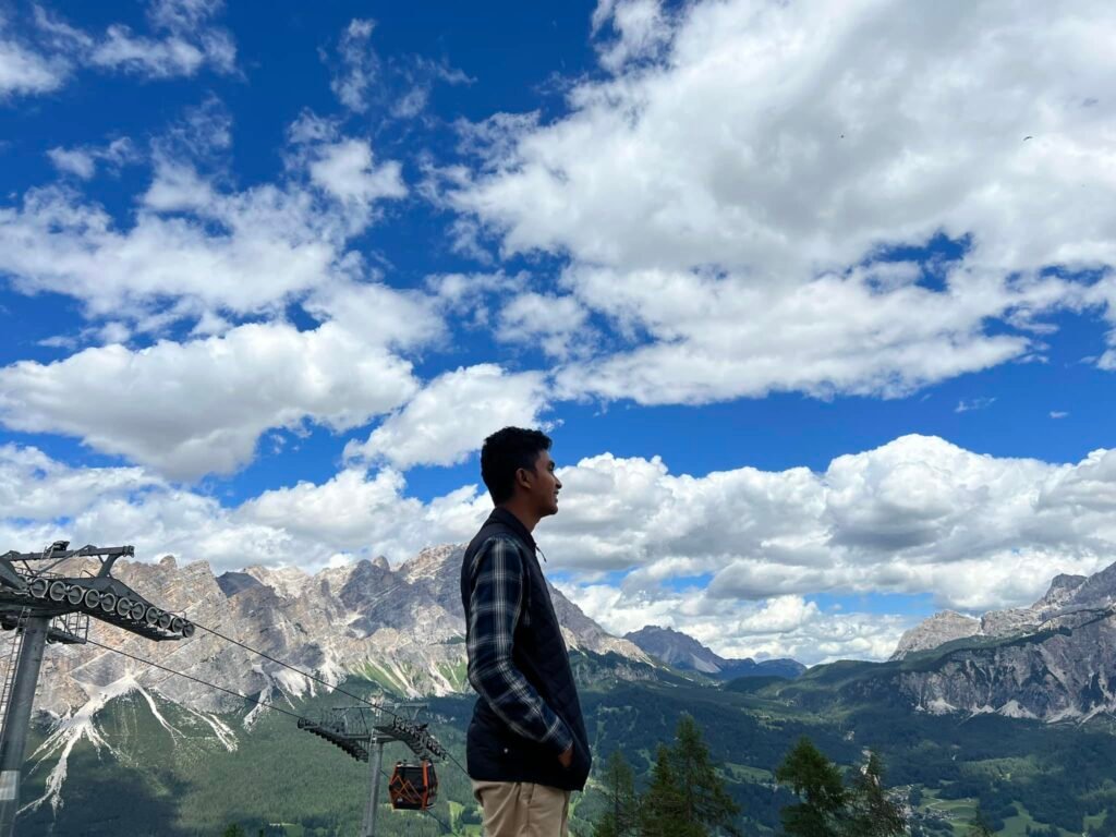 A man standing top of a hill